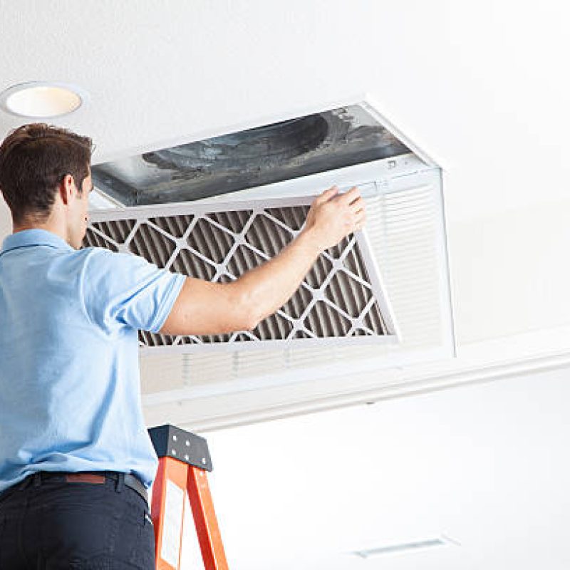 Man cleaning air ducts in home.